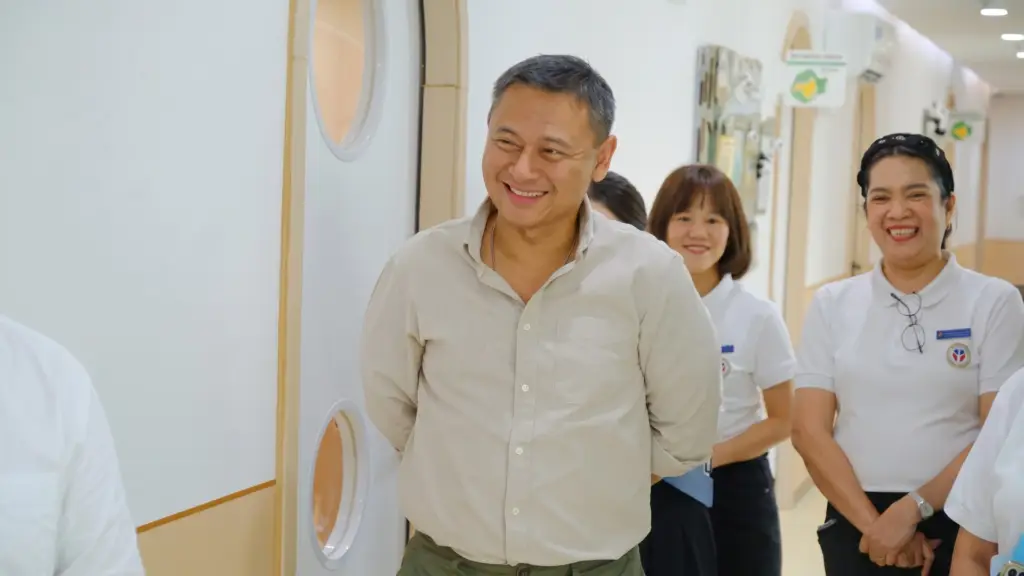 Education Secretary Sonny Angara smiling warmly alongside welcoming faculty members during a special campus tour and school visit at Sproutville International School.